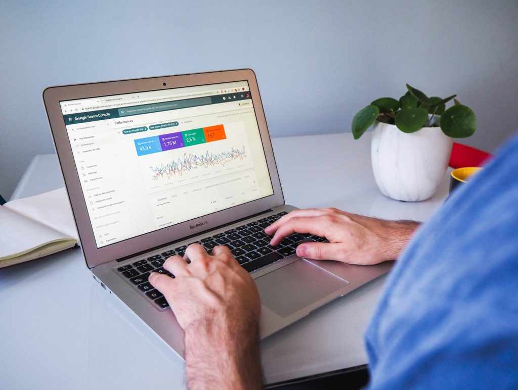 a person working at a laptop which is displaying analytics data